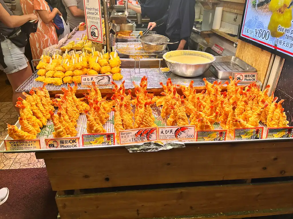 A Kyoto street food stall displaying resin tempura models that look freshly fried